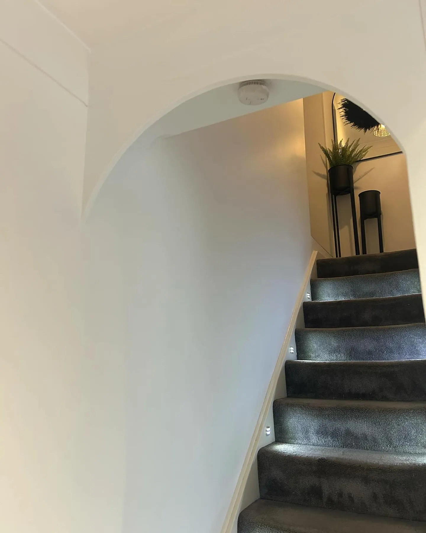 A set of stairs leading up to a living room.