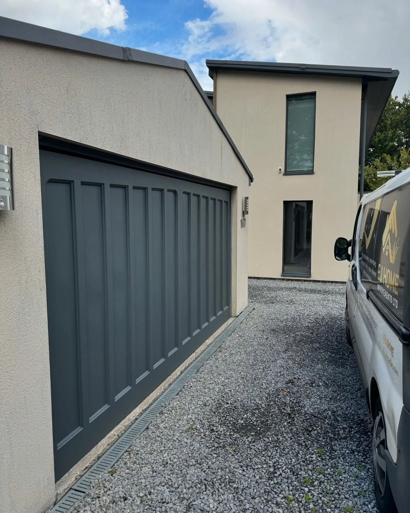 A white van parked in front of a house.