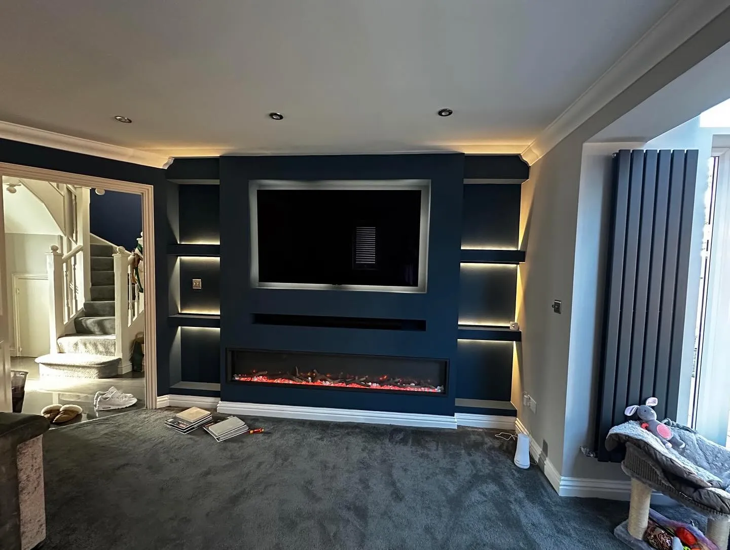 A living room with a fireplace and a flat screen tv.