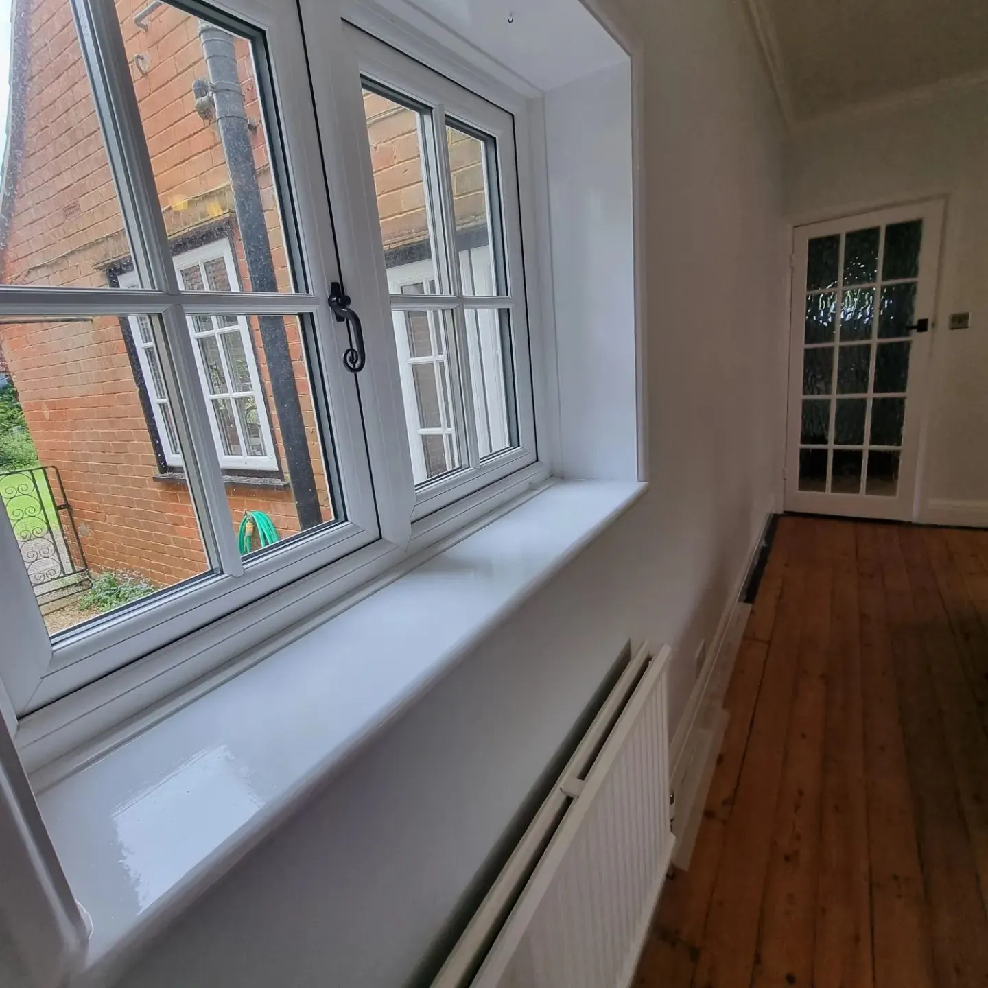 A room with a wooden floor and a window.
