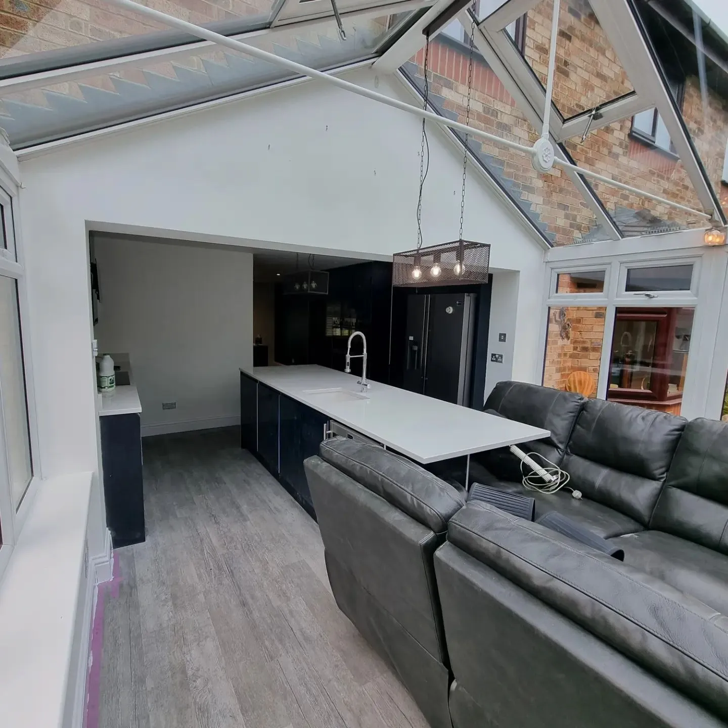 A living room filled with furniture and a kitchen.