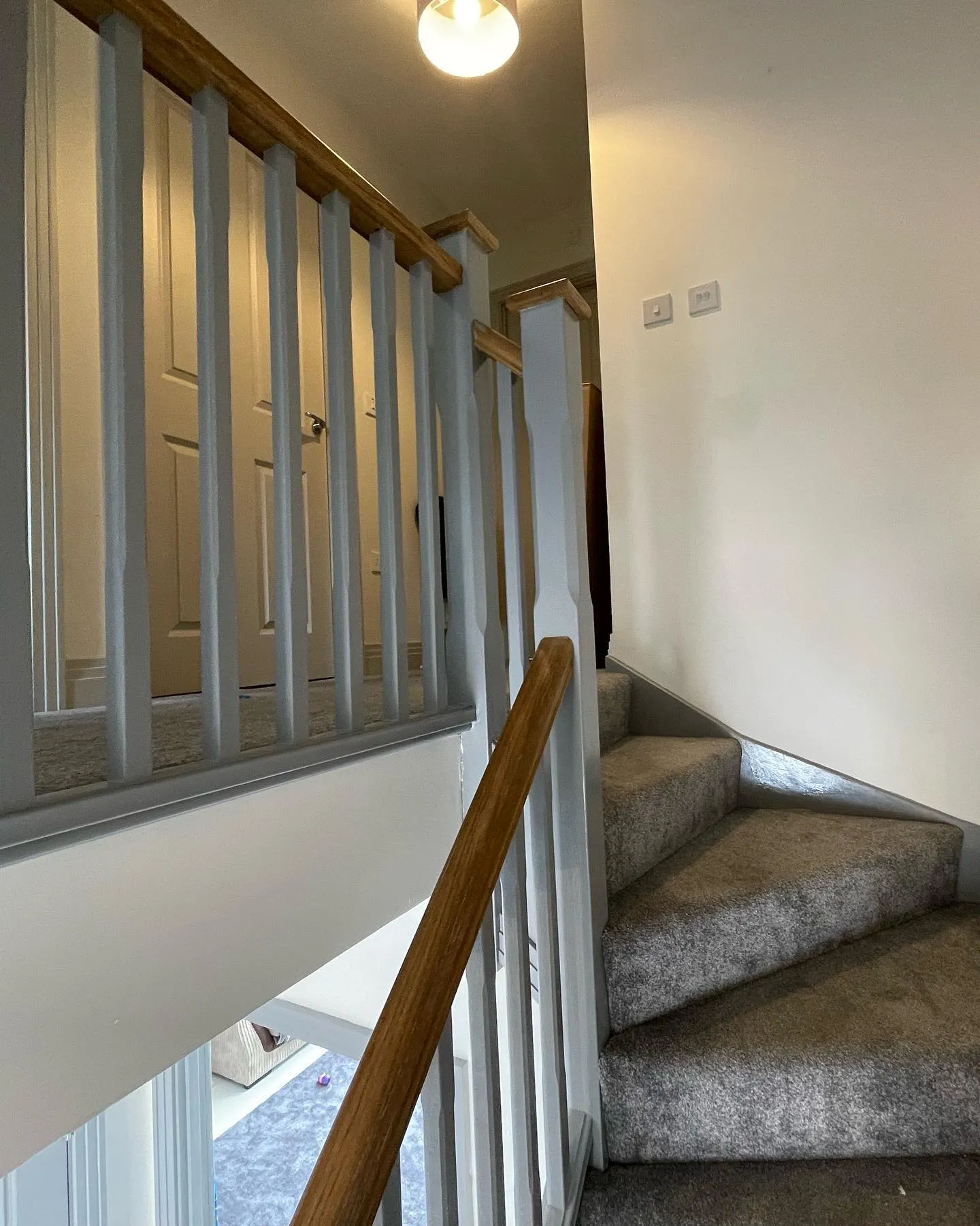A staircase with a light hanging above it.