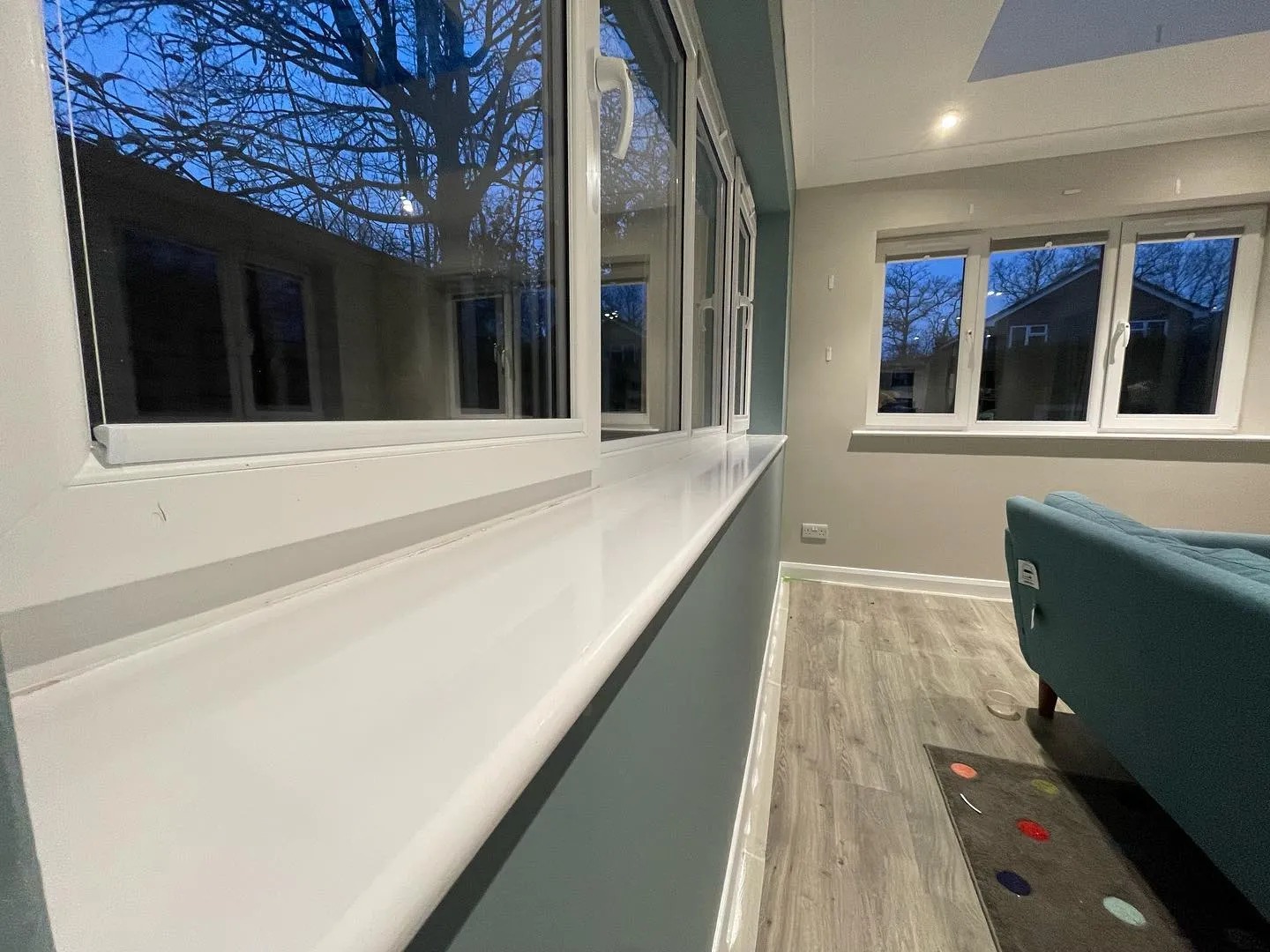 A room with a couch and a large window.