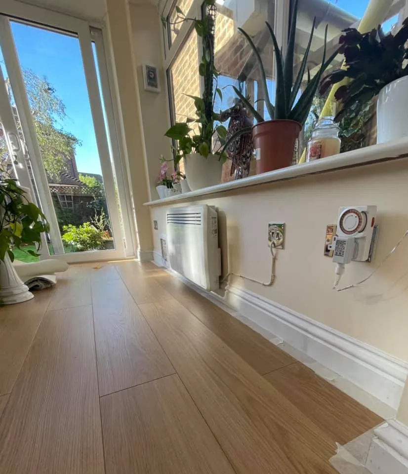 A room with a wooden floor and a window.